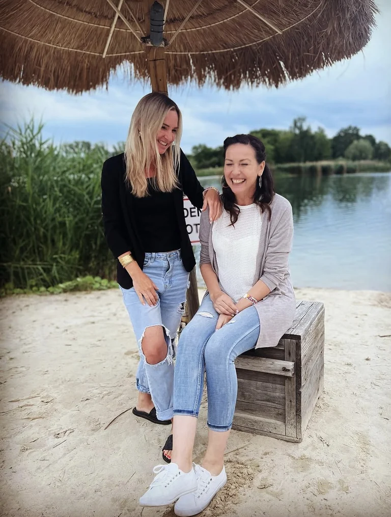 Wena and Janet laugh together at the water
